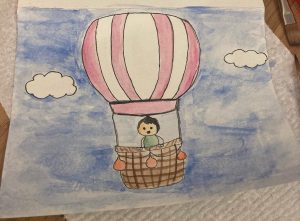 Water colour of a cartoon woman in a hot air balloon